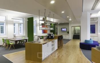 Well-appointed office space rental in Fleischmarkt 1, 1010 Vienna, with a comfortable lounge area and modern amenities.